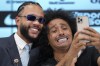 Soccer player Memphis Depay, of the Netherlands, left, poses for a selfie with TV reporter Papi during his media presentation as a new player for the Corinthians at Neo Quimica arena in Sao Paulo, Thursday, Sept. 12, 2024. (AP Photo/Andre Penner)