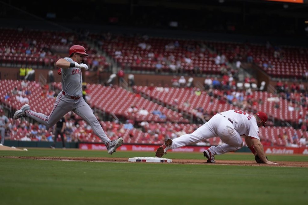 Cincinnati Reds' Spencer Steer, left, grounds out as St. Louis Cardinals first baseman Paul Goldschmidt reaches for the throw during the fifth inning of a baseball game Thursday, Sept. 12, 2024, in St. Louis. (AP Photo/Jeff Roberson)