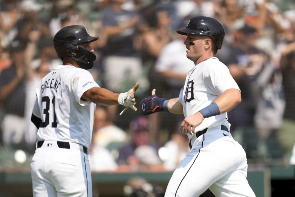 Detroit Tigers' Jace Jung, right, celebrates scoring with Riley Greene (31) against the Colorado Rockies in the fourth inning of a baseball game, Thursday, Sept. 12, 2024, in Detroit. (AP Photo/Paul Sancya)