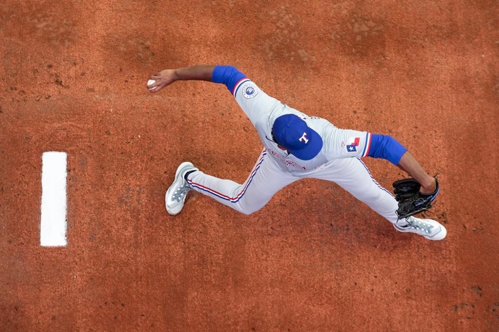 Texas Rangers starting pitcher Kumar Rocker warms up before his major league debut against the Seattle Mariners in a baseball game Thursday, Sept. 12, 2024, in Seattle. (AP Photo/Lindsey Wasson)