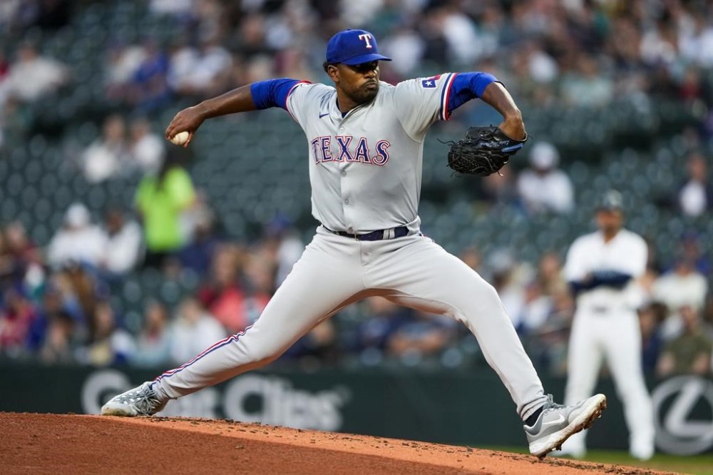 Texas Rangers starting pitcher Kumar Rocker throws against the Seattle Mariners during the second inning of a baseball game in his major league debut, Thursday, Sept. 12, 2024, in Seattle. (AP Photo/Lindsey Wasson)
