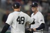 New York Yankees pitcher Clay Holmes, right, is greeted by Anthony Rizzo (48) during the tenth inning of a baseball game against the Boston Red Sox at Yankee Stadium Thursday, Sept. 12, 2024, in New York. The Yankees defeated the Red Sox 2-1. (AP Photo/Seth Wenig)