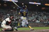 Milwaukee Brewers' Jackson Chourio, right, hits a two-run home run during the eighth inning of a baseball game against the San Francisco Giants, Thursday, Sept. 12, 2024. (AP Photo/Kavin Mistry)