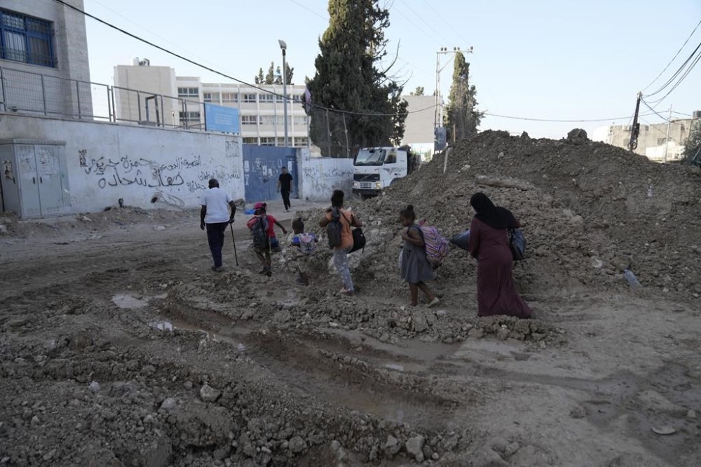 Palestinian refugees flee the West Bank refugee camp of Tulkarem, during an Israeli army operation in Tulkarem, Thursday, Sept. 12, 2024. (AP Photo/Nasser Nasser)