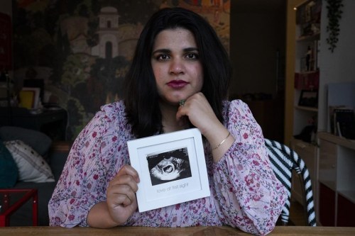 Sanniah Jabeen poses for a photograph holding a print of an ultrasound of her unborn baby boy Waleed who died after Sanniah contracted listeria, in Toronto, on Thursday, Sept. 5, 2024. THE CANADIAN PRESS/Arlyn McAdorey