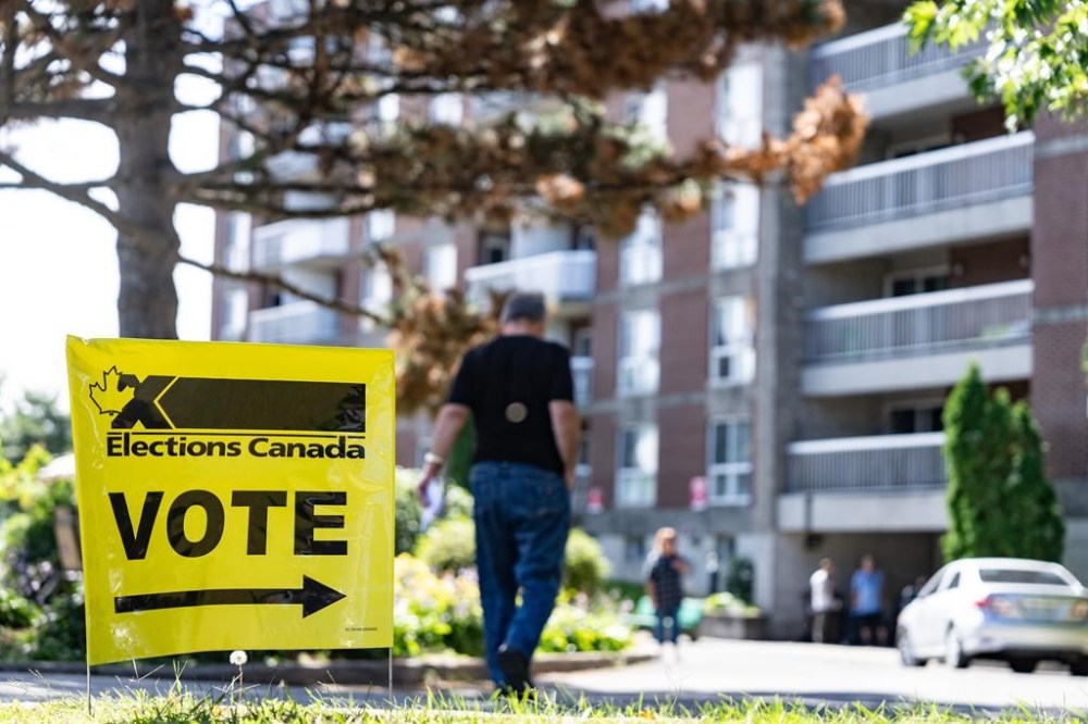 A voter looks at the ballot list as they head to advance polls in Lasalle, Que., Monday, Sept. 9, 2024. People in two federal ridings are choosing their next member of Parliament today, and political parties are closely watching the results. THE CANADIAN PRESS/Christinne Muschi