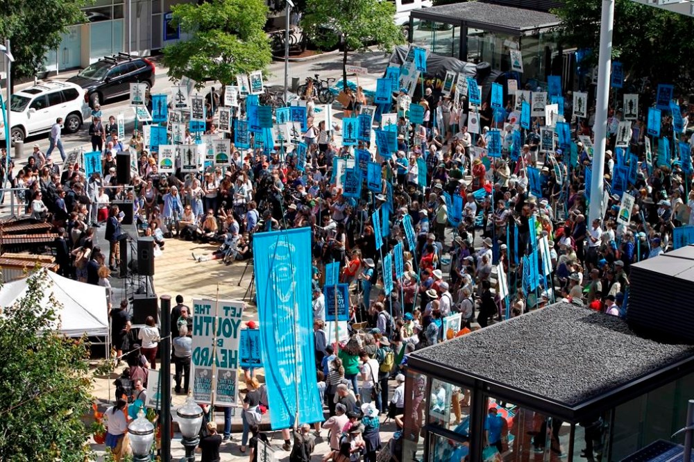 FILE - Supporters attend a rally for a group of young people who filed a lawsuit saying U.S. energy policies are causing climate change and hurting their future, in Portland, Ore., June 4, 2019. (AP Photo/Steve Dipaola, File)