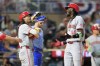 Cincinnati Reds Elly De La Cruz (44) celebrates with teammates after hitting a grand slam during the seventh inning of a baseball game against the Minnesota Twins, Friday, Sept. 13, 2024, in Minneapolis. (AP Photo/Nikolas Liepins)