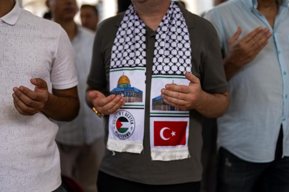 Men attend a funeral prayer in abstentia ceremony in memory of Turkish-American activist Aysenur Ezgi Eygi killed by Israeli gunfire, at Fatih mosque in Istanbul, Turkey, Friday, Sept. 13, 2024. (AP Photo/Francisco Seco)
