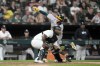 Oakland Athletics' Jacob Wilson, top, scores behind Chicago White Sox catcher Chuckie Robinson during the sixth inning of a baseball game Saturday, Sept. 14, 2024, in Chicago. (AP Photo/Charles Rex Arbogast)