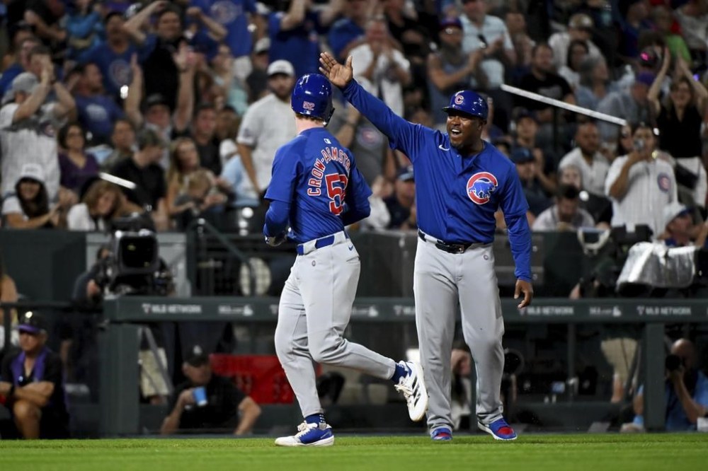 Chicago Cubs' Pete Crow-Armstrong, left, celebrates with third base coach Willie Harris while running the bases after hitting a home run in the seventh inning of a baseball game against the Colorado Rockies, Saturday, Sept. 14, 2024, in Denver. (AP Photo/Geneva Heffernan)