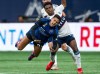 San Jose Earthquakes' Hernan, left, and Vancouver Whitecaps' Ralph Priso collide as they vie for the ball during the first half of an MLS soccer match in Vancouver, on Saturday, Sept. 14, 2024. THE CANADIAN PRESS/Ethan Cairns