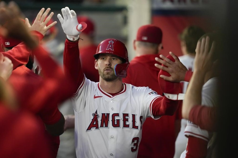 Los Angeles Angels' Taylor Ward (3) celebrates in the dugout after scoring off of a single hit by Nolan Schanuel during the first inning of a baseball game against the Houston Astros in Anaheim, Calif., Saturday, Sept. 14, 2024. (AP Photo/Ashley Landis)