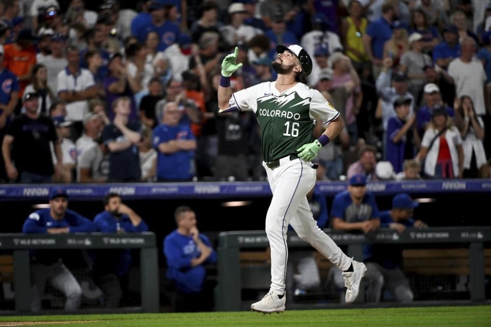 Colorado Rockies' Sam Hilliard celebrates after hitting a game-tying two-run home run in the ninth inning of a baseball game against the Chicago Cubs, Saturday, Sept. 14, 2024, in Denver. (AP Photo/Geneva Heffernan)