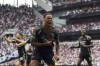 Arsenal's Gabriel, foreground, celebrates after scoring the opening goal during the English Premier League soccer match between Tottenham Hotspur and Arsenal in London, Sunday, Sept. 15, 2024. (John Walton/PA via AP)