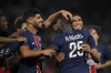 PSG's Achraf Hakimi, right, celebrates with teammate Nuno Mendes after scoring his side's fourth goal during the French League 1 soccer match between Paris Saint-Germain and Montpellier at the Parc des Princes in Paris, Friday, Aug. 23, 2024. (AP Photo/Thibault Camus)