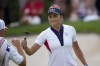 United States' Lexi Thompson bumps fists with her caddie after making a putt on the seventh green during a Solheim Cup golf tournament singles match at the Robert Trent Jones Golf Club, Sunday, Sept. 15, 2024, in Gainesville, Va. (AP Photo/Matt York)
