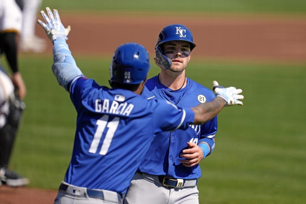 Kansas City Royals' Michael Massey, right, is greeted by Maikel Garcia (11) after scoring on a sacrifice fly by Yuli Gurriel off Pittsburgh Pirates starting pitcher Jared Jones during the second inning of a baseball game in Pittsburgh, Sunday, Sept. 15, 2024. (AP Photo/Gene J. Puskar)
