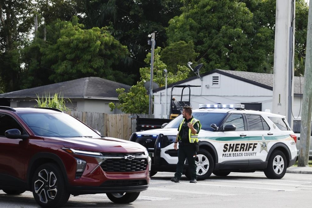 A police officer directs traffic near Trump International Golf Club after the apparent assassination attempt of Republican presidential nominee former President Donald Trump in West Palm Beach, Fla., Sunday, Sept. 15, 2024. (AP Photo/Terry Renna)