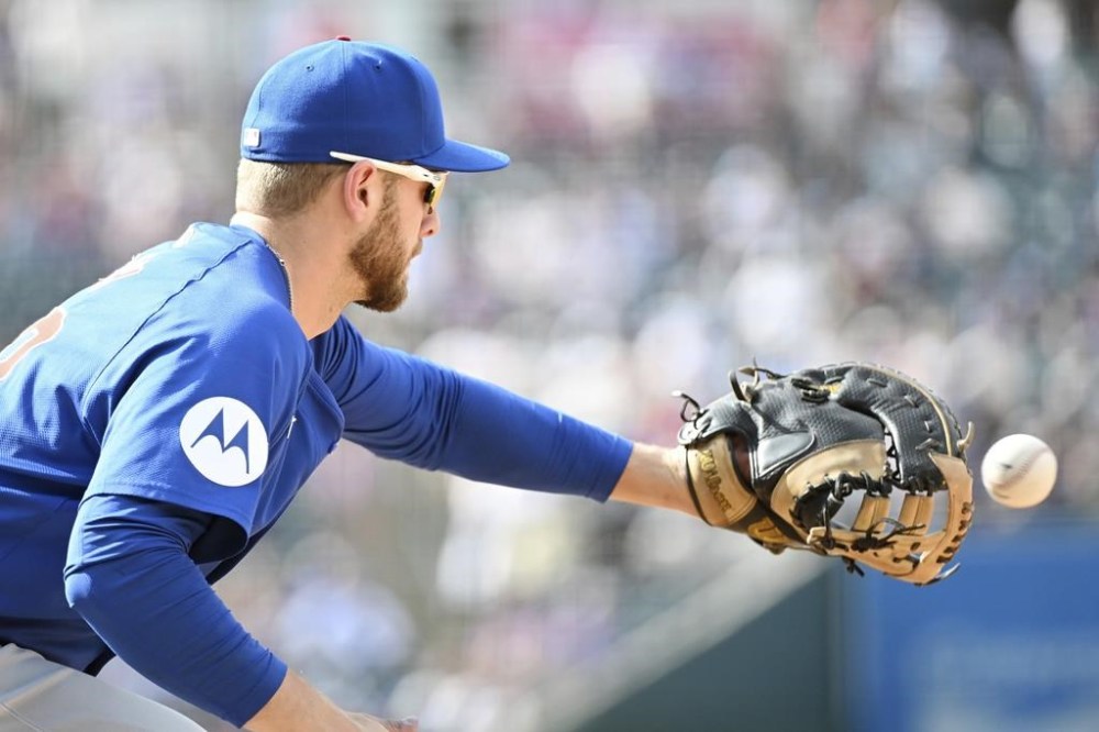 Chicago Cubs first baseman Michael Busch catches a baseball for an out at first base in the eighth inning of a baseball game against the Colorado Rockies, Sunday, Sept. 15, 2024, in Denver. (AP Photo/Geneva Heffernan)