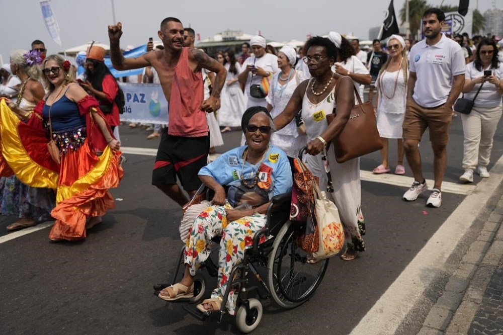 Faithful from various religions participate in the Defense of Religious Freedom march at Copacabana beach in Rio de Janeiro, Sunday, Sept. 15, 2024. The march seeks to bring attention to religious intolerance in the country. (AP Photo/Silvia Izquierdo)