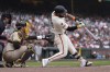 San Francisco Giants' Heliot Ramos, right, hits a home run in front of San Diego Padres catcher Kyle Higashioka during the ninth inning of a baseball game in San Francisco, Sunday, Sept. 15, 2024. (AP Photo/Jeff Chiu)