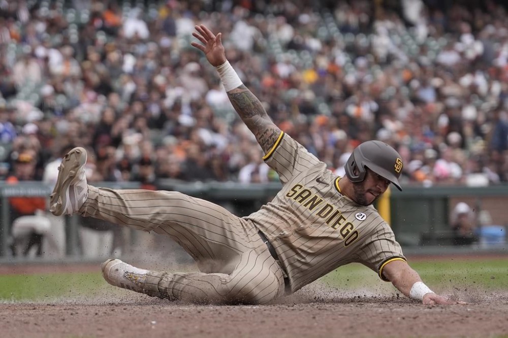 San Diego Padres' David Peralta slides home to score against the San Francisco Giants during the 10th inning of a baseball game in San Francisco, Sunday, Sept. 15, 2024. (AP Photo/Jeff Chiu)