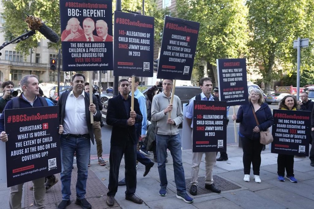 A small number of protesters wait for Huw Edwards an ex-BBC news presenter to arrive at Westminster Magistrate's Court for sentencing after he pleaded guilty to three counts of making indecent images of children in London, Monday, Sept. 16, 2024. (AP Photo/Frank Augstein)