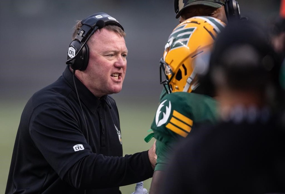Edmonton Elks head coach Chris Jones speaks to a player while taking on the Hamilton Tiger-Cats during second half CFL action in Edmonton on Thursday July 13, 2023. It hasn't taken Jones long to make an impact with the Hamilton Tiger-Cats. Jones was hired as Hamilton's senior defensive assistant following the club's 47-22 home loss to Edmonton on Aug. 17. THE CANADIAN PRESS/Jason Franson.