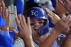 Kansas City Royals' Bobby Witt Jr. celebrates with teammates in the dugout after hitting a grand slam during the third inning of a baseball game against the Detroit Tigers Monday, Sept. 16, 2024, in Kansas City, Mo. (AP Photo/Charlie Riedel)