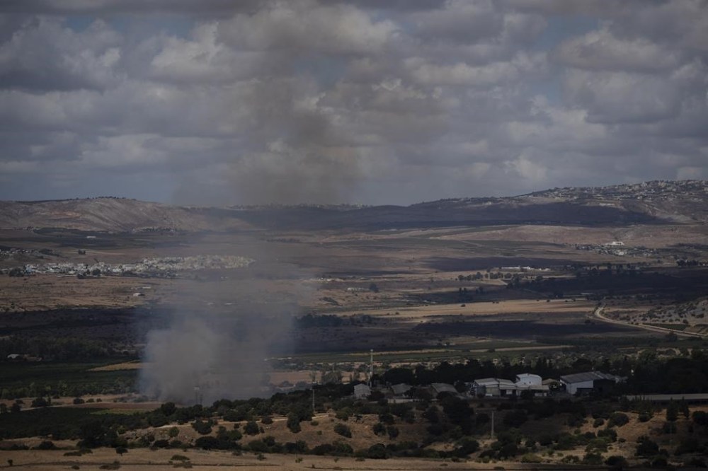 Smoke rises to the sky as fire burns in an area, following an attack from Lebanon, near the Kibbutz Snir, as seen from the Israeli-annexed Golan Heights, Monday, Sept. 16, 2024. (AP Photo/Leo Correa)