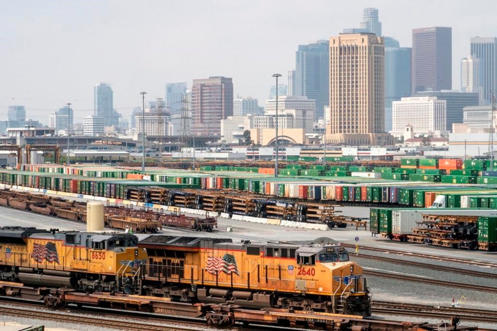 FILE - Los Angeles skyline is seen above the Union Pacific LATC Intermodal Terminal is seen on Tuesday, April 25, 2023 in Los Angeles. (AP Photo/Damian Dovarganes, File)