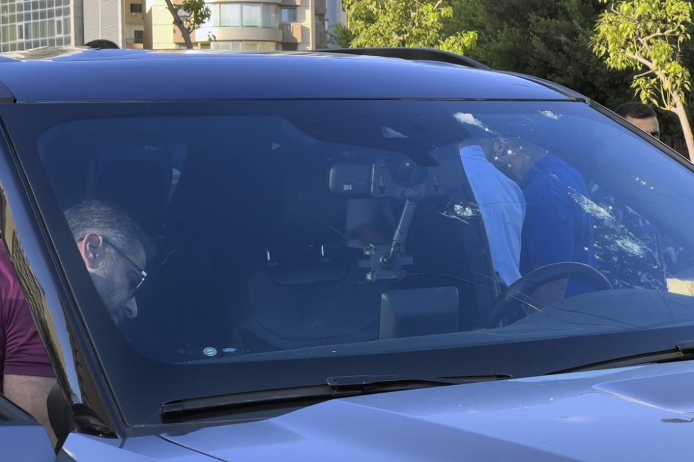 Police officers inspect a car inside of which a hand-held pager exploded, Beirut, Lebanon, Tuesday, Sept. 17, 2024. (AP Photo/Hussein Malla)