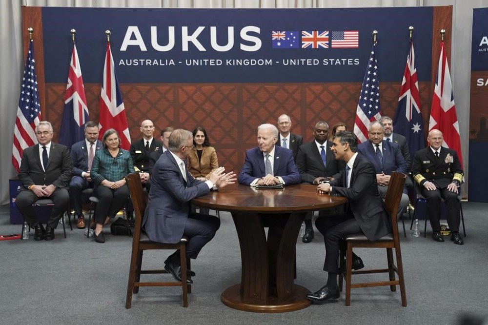 Britain's former prime minister Rishi Sunak, right, meets with U.S. President Joe Biden and Prime Minister of Australia Anthony Albanese, left, at Point Loma naval base in San Diego, U.S., Monday March 13, 2023, as part of AUKUS, a trilateral security pact between Australia, the U.K., and the U.S. Canada is in consultations with the U.K., the U.S. and Australia about possible collaboration in the security pact known as AUKUS. (Stefan Rousseau/Pool via AP)