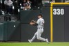 Cleveland Guardians left fielder Steven Kwan chases a fly ball hit by Chicago White Sox's Andrew Vaughn during the seventh inning of a baseball game Monday, Sept. 9, 2024, in Chicago. (AP Photo/Erin Hooley)