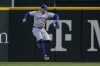 Toronto Blue Jays right fielder George Springer grabs a two-run single by Texas Rangers' Adolis Garcia in the fourth inning of a baseball game in Arlington, Texas, Tuesday, Sept. 17, 2024. (AP Photo/Tony Gutierrez)