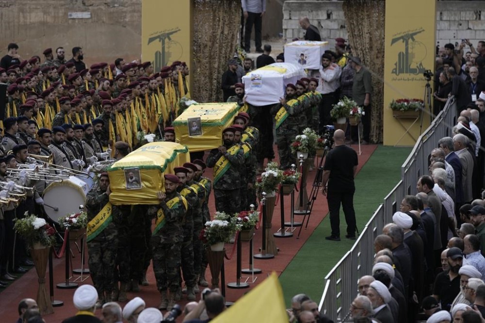 CORRECTS DAY TO TUESDAY WHEN KILLED Hezbollah fighters carry the coffins of fallen four comrades who were killed Tuesday after their handheld pagers exploded, during their funeral procession in the southern suburb of Beirut, Lebanon, Wednesday, Sept. 18, 2024. (AP Photo/Bilal Hussein)