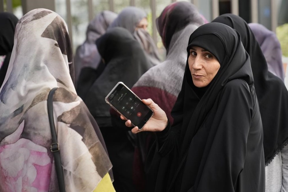CORRECTS DAY TO TUESDAY WHEN INJURED - Families of victims who were injured Tuesday by their exploded handheld pagers, wait at the emergency entrance of the American University hospital, in Beirut, Lebanon, Wednesday, Sept. 18, 2024. (AP Photo/Hussein Malla)