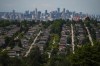 The downtown Vancouver skyline is seen in the distance beyond houses in Burnaby, B.C., on Wednesday, July 12, 2023. A report led by the Canada Research Chair in Urban Governance, David Wachsmuth, says clampdowns on short-term rentals in British Columbia have reduced rents by 5.7 per cent, saving tenants more than $600 million last year. THE CANADIAN PRESS/Darryl Dyck