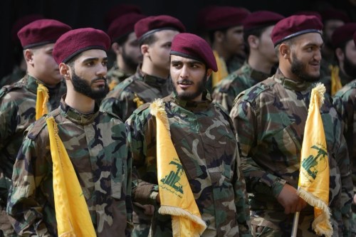 Hezbollah members attend the funeral of two of their comrades who were killed on Wednesday when a handheld device exploded, during a funeral procession in the southern suburbs of Beirut, Thursday, Sept. 19, 2024. (AP Photo/Hussein Malla)