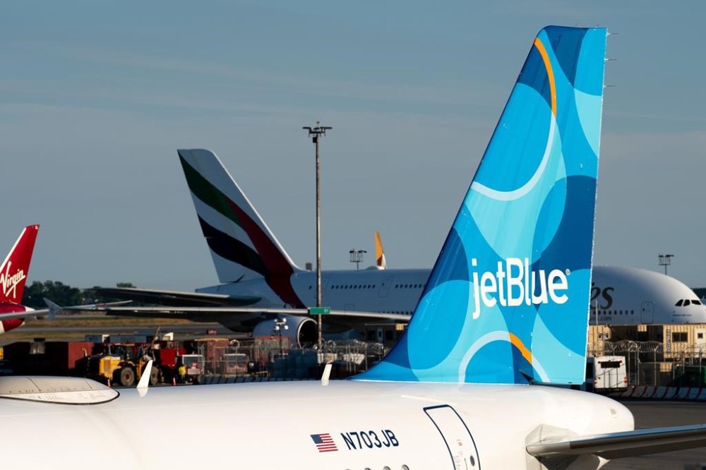 FILE - A JetBlue airplane is seen parked on the tarmac at John F. Kennedy International Airport on Tuesday, June 28, 2022, in New York. (AP Photo/Julia Nikhinson, File)