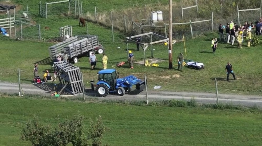 Emergency personnel respond to the scene where a wagon ride overturned at an apple orchard in Lafayette, Wis., on Wednesday, Sept. 18, 2024. (WQOW via AP)