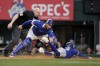 Texas Rangers catcher Carson Kelly tags out Toronto Blue Jays' Ernie Clement, right, who was trying to score on a Vladimir Guerrero Jr. single as umpire Mike Estabrook, left, looks on in the fourth inning of a baseball game in Arlington, Texas, Thursday, Sept. 19, 2024. (AP Photo/Tony Gutierrez)