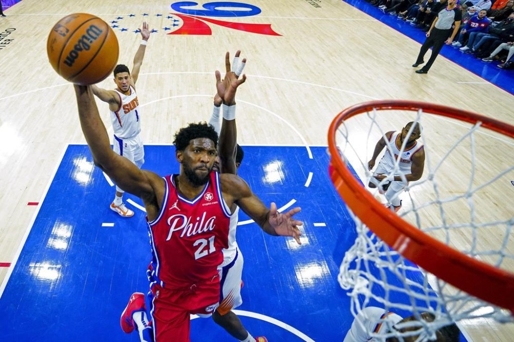 FILE - Joel Embiid of the Philadelphia 76ers goes for the dunk during the second half of an NBA basketball game against the Phoenix Suns, Tuesday, Feb. 8, 2022, in Philadelphia. (AP Photo/Chris Szagola, file)