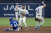 Tampa Bay Rays' Jonathan Aranda (62) steps out of the way as Tampa Bay shortstop José Caballero, center, holds up on a throw to first after forcing out Toronto Blue Jays' Leo Jiménez at second base during the fourth inning of a baseball game Friday, Sept. 20, 2024, in St. Petersburg, Fla. (AP Photo/Steve Nesius)