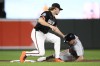 Baltimore Orioles shortstop Gunnar Henderson, left, tags out Detroit Tigers' Kerry Carpenter, right, as he tried to steal second base during the first inning of a baseball game, Friday, Sept. 20, 2024, in Baltimore. (AP Photo/Nick Wass)