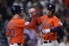 Houston Astros' Alex Bregman, right, celebrates with Kyle Tucker, left, after hitting a two-run home run during the third inning of a baseball game against the Los Angeles Angels, Friday, Sept. 20, 2024, in Houston. (AP Photo/Kevin M. Cox)