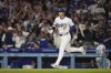 Los Angeles Dodgers designated hitter Shohei Ohtani (17) runs the bases after hitting a home run during the fifth inning of a baseball game against the Colorado Rockies in Los Angeles, Friday, Sept. 20, 2024. Max Muncy also scored. (AP Photo/Ashley Landis)
