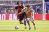 Genoa's Ruslan Malinovskyi and Roma's Niccolo Pisilli, left, in action during the Serie A soccer match between Genoa and Roma at the Luigi Ferraris Stadium in Genoa, Italy, Sunday, Sept. 15, 2024. (Tano Pecoraro/LaPresse via AP)