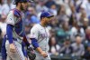 Texas Rangers catcher Jonah Heim walks back to the mound with relief pitcher Gerson Garabito, right, after a single by Seattle Mariners' Luke Raley during the eighth inning of a baseball game Sunday, Sept. 15, 2024, in Seattle. (AP Photo/Lindsey Wasson)